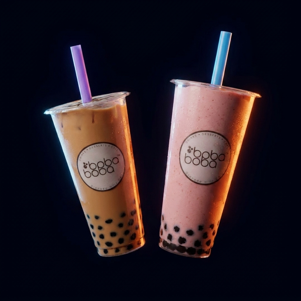A classic milk tea and strawberry smoothie floating against a dark studio backdrop