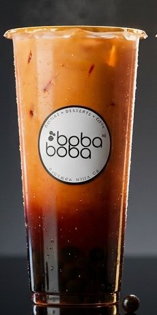 Amber Earl Grey jasmine milk tea over dark pearls